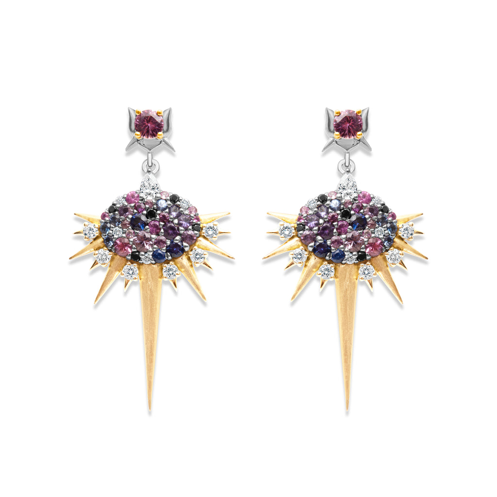  Multicolored bespoke sapphire and diamond drop earrings. Earring stud is a white gold butterfly-shaped design with a round pink sapphire. From the stud, a single white gold chain link connects to a tear-drop diamond. From there, a horizontal oval shape design with round mixed color sapphires and clear and black diamonds of varying sizes. Spikes of yellow gold extend outwards below the oval, with an extra-long spike extending straight down. Spikes are intercut with 6 round brilliant cut diamonds.