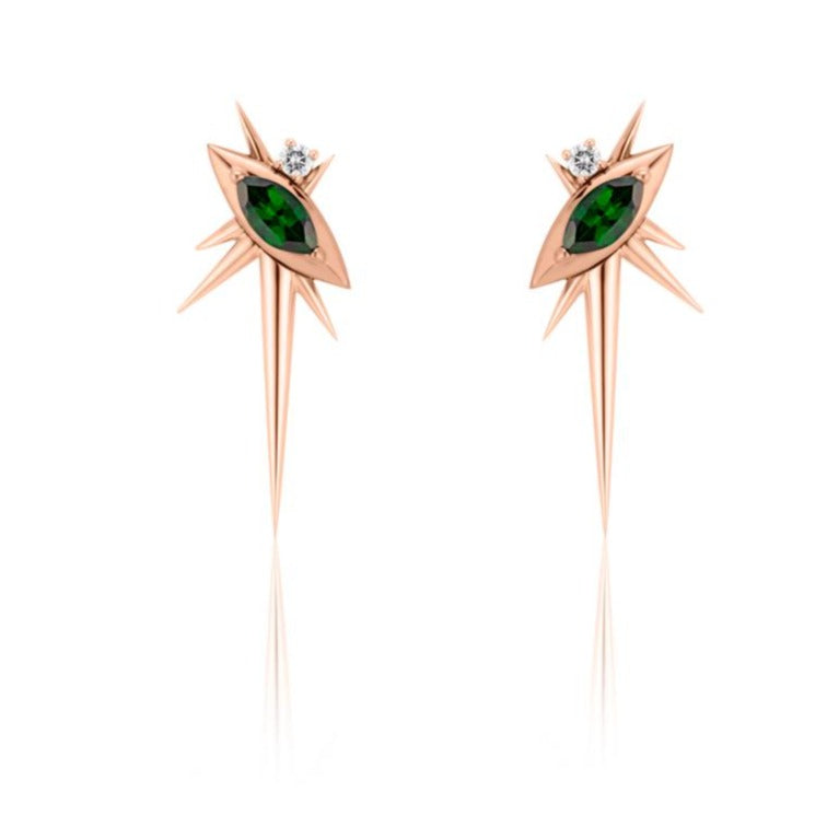 Front view of alternative drop earrings, each with 1 marquise-shaped tsavorite, set at a 45-degree angle, with a small round diamond above. 6 rose gold spikes of varying lengths extend from the setting, with a large, long spike pointed down. 