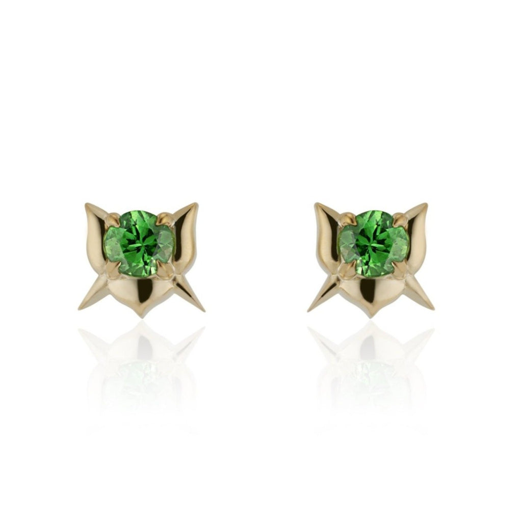 Round tsavorite garnet in a rosebud-shaped yellow gold setting. 2 short yellow gold spikes extend down diagonally in either direction creating an X formation, mirroring the top petals of the rosebud.
