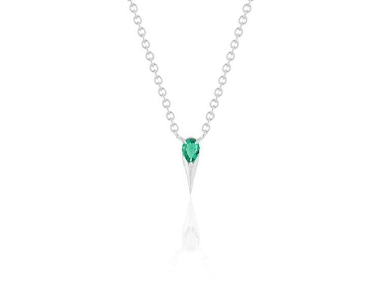  Front view of unique emerald pendant necklace connected to a white gold round-link chain by 2 angled white gold prongs. The pear-shaped emerald stone is set at the top of a white gold spike that drops below, forming a water droplet shape.