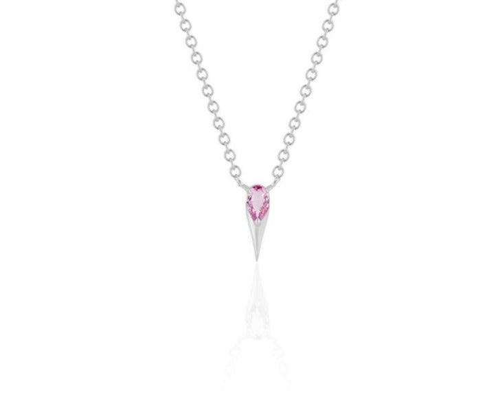  Front view of unique pink sapphire pendant necklace connected to a white gold round-link chain by 2 angled white gold prongs. The pear-shaped pink sapphire stone is set at the top of a white gold spike that drops below, forming a water droplet shape. 