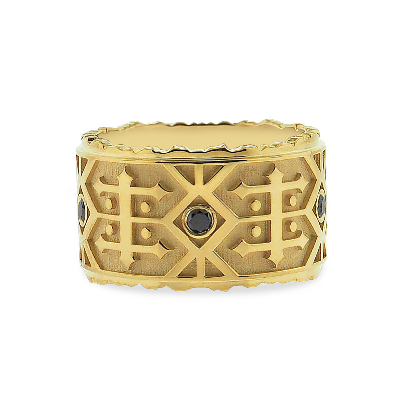 Side view of black diamond wedding band. Polished yellow gold irregular edges at the ring’s top and bottom appear as the jagged peaks of a mountain range. The textured matte-finished base provides definition for the polished Navajo-inspired detail.