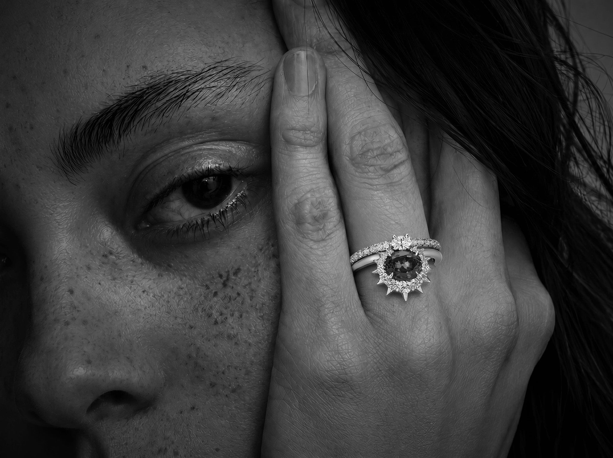 White gold ring with a central Asscher cut champagne diamond flanked by two smaller white diamonds.