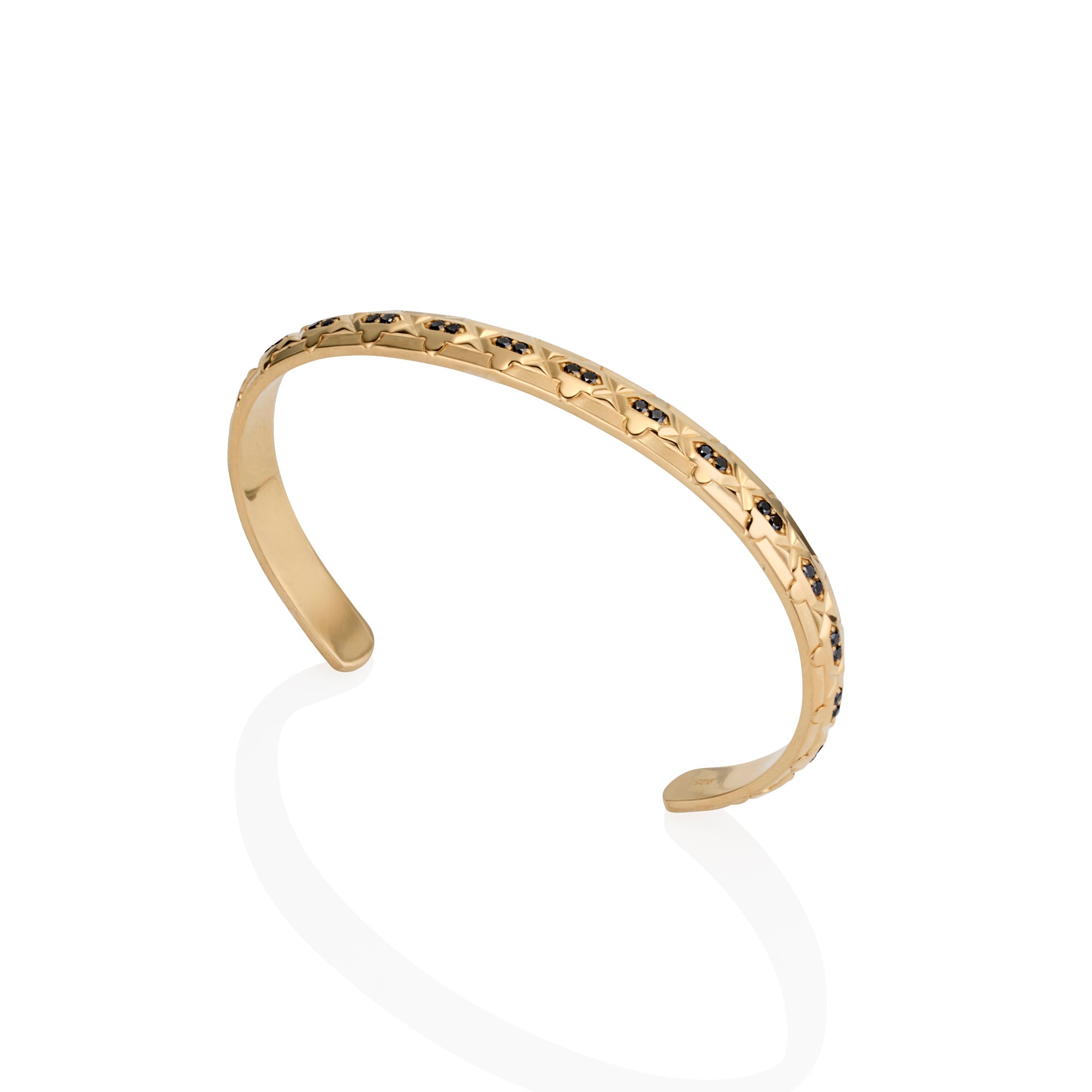 Gold bracelet with black diamonds on a white background