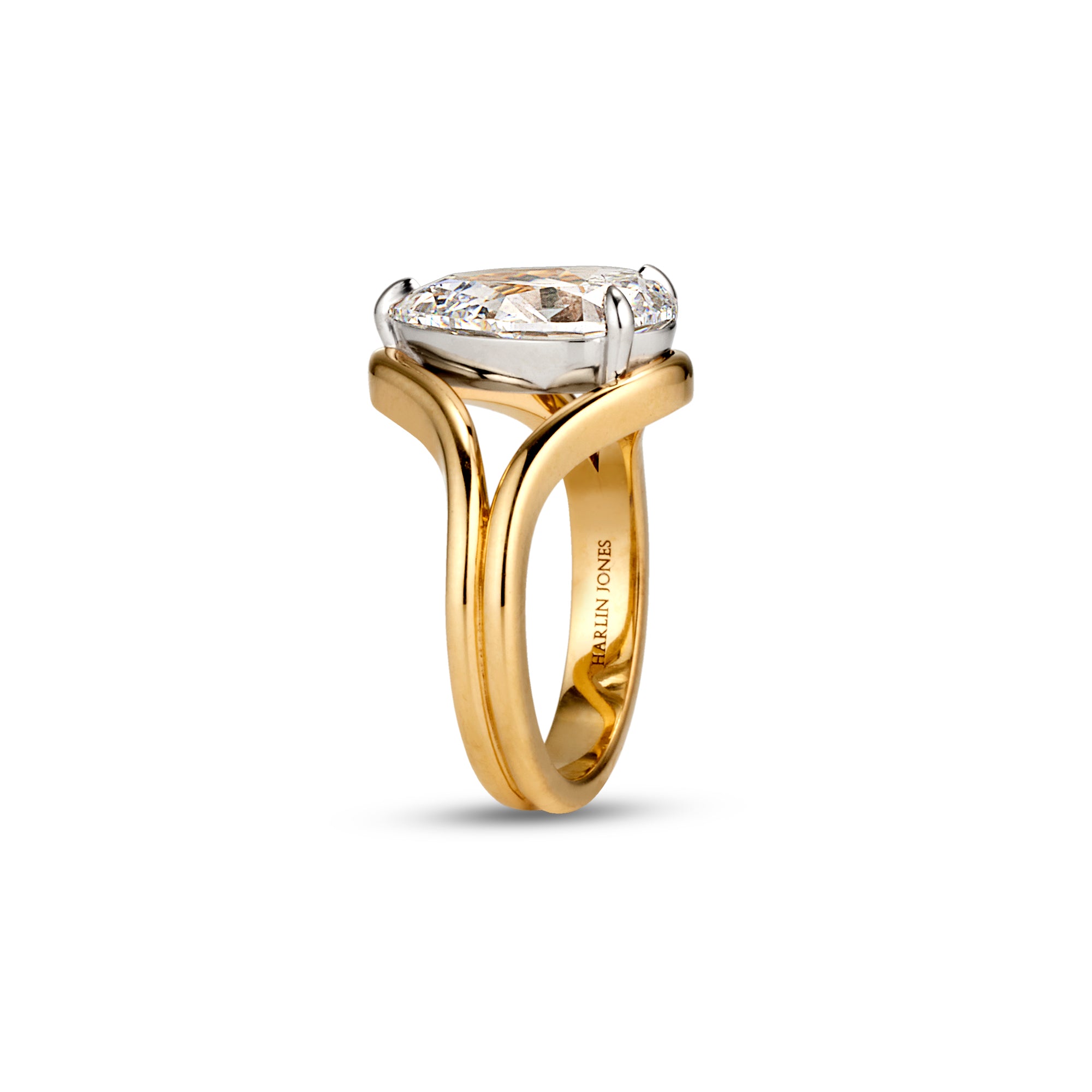 A two-tone diamond ring by Harlin Jones, featuring a Pear-cut diamond set in a yellow gold and white gold split-shank band, shown on a clean white background.