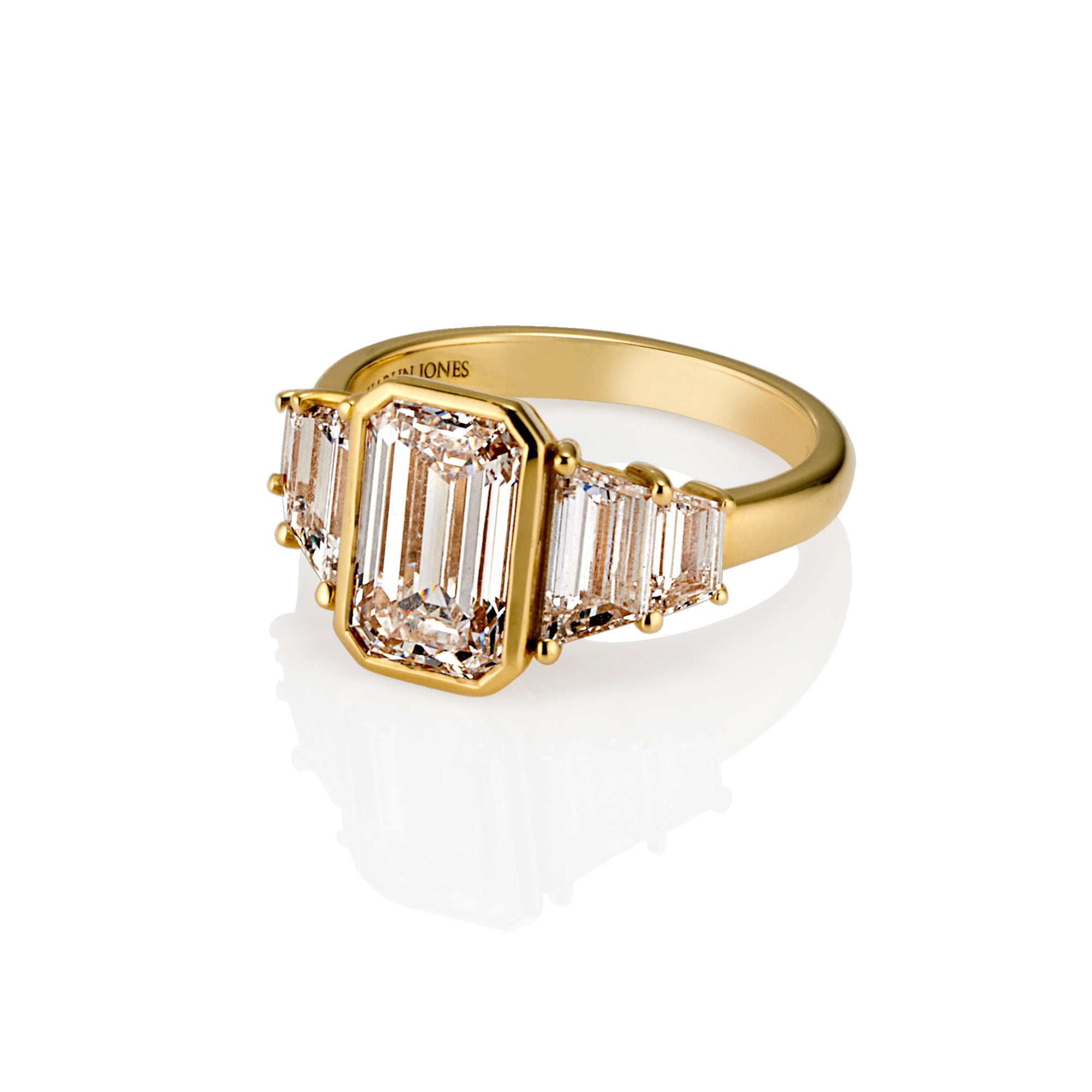 Bezel set 2ct emerald cut diamond F VS1 with trapezoid diamond accents detail