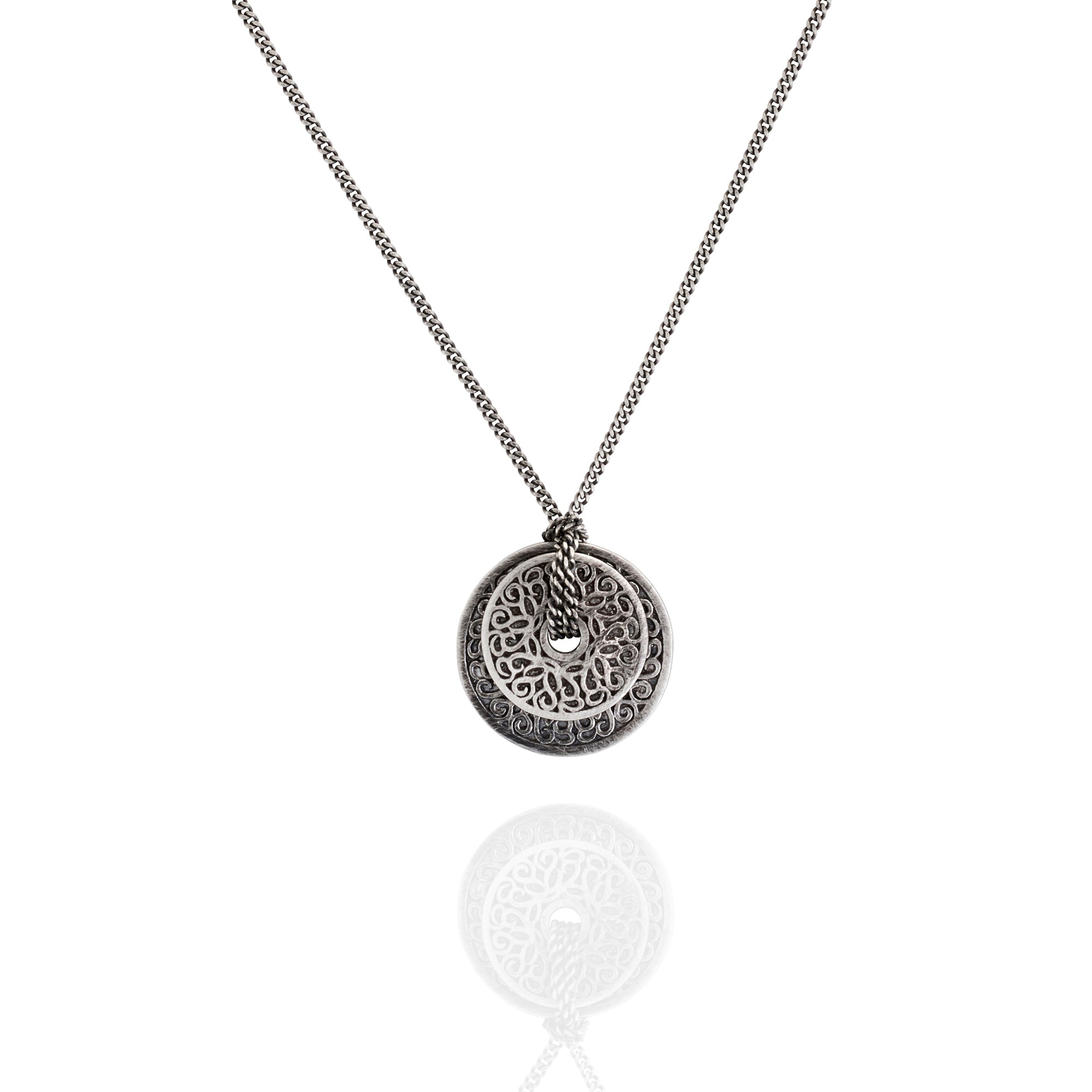 Silver coin necklace with a intricate pendant on a white background