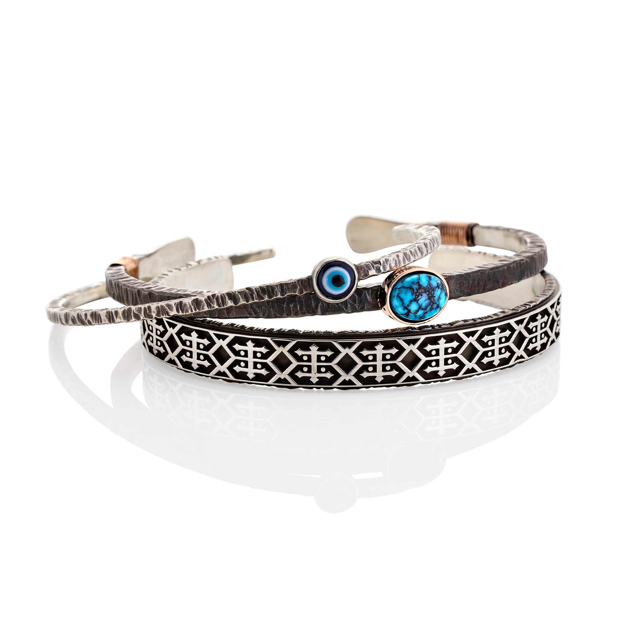 Set of three bracelets with different designs on a white background