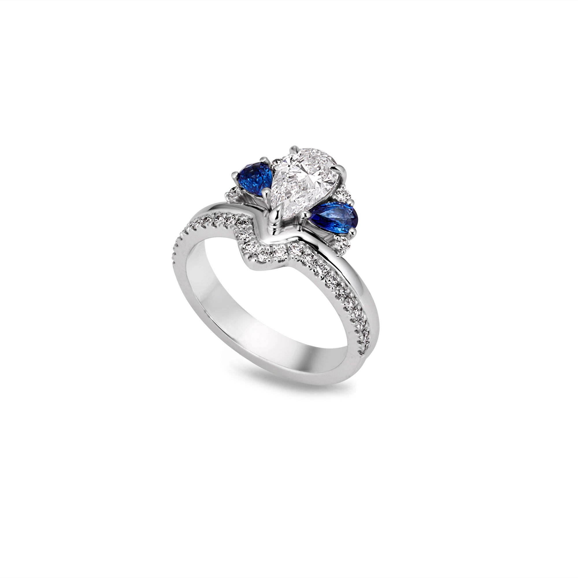 Front side angle of  ring white gold with a central large pear-shaped white diamond, flanked by  blue sapphires, and a band encrusted with small sparkling diamond