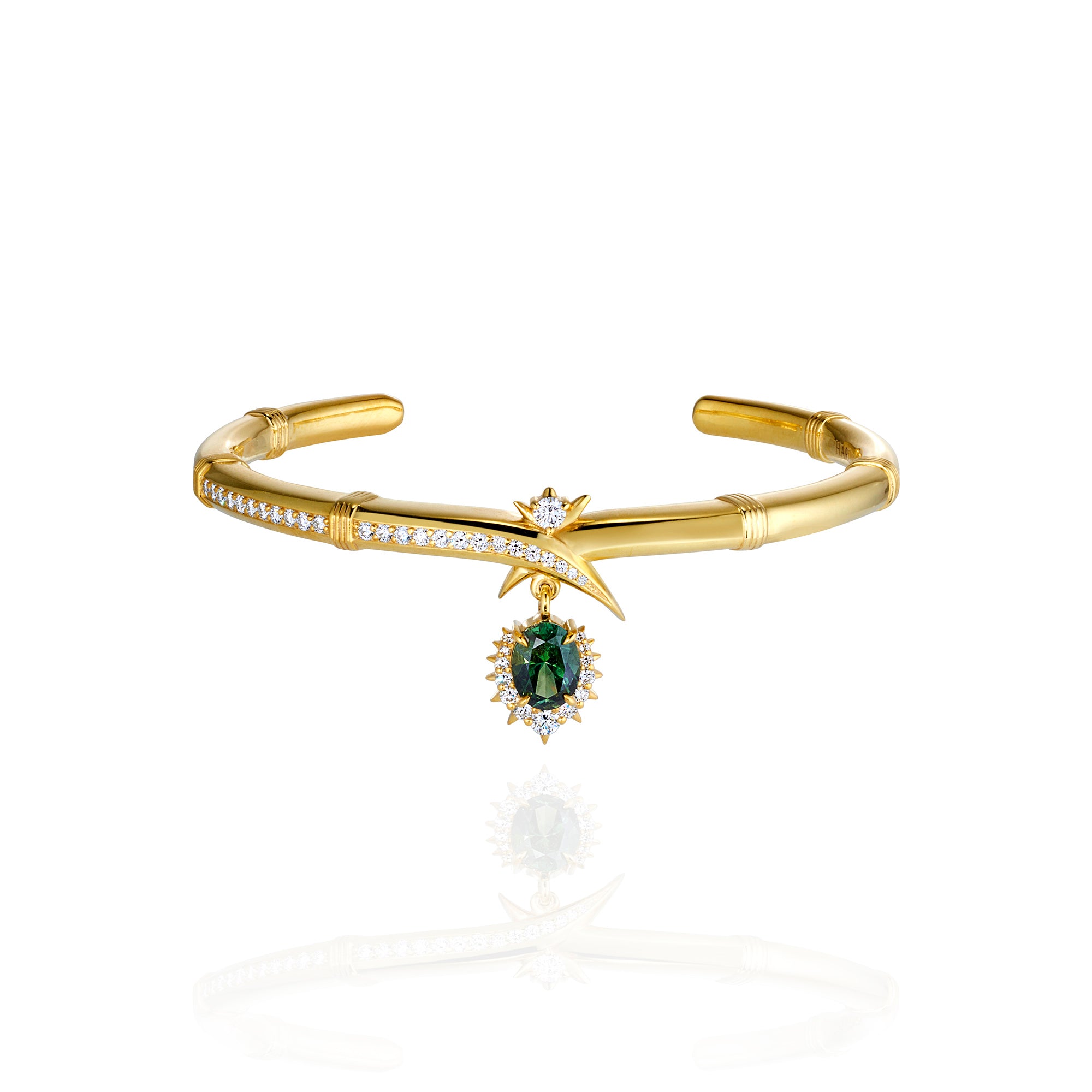 A luxurious gold bracelet with a prominent green stone, accented by delicate diamonds for added brilliance.