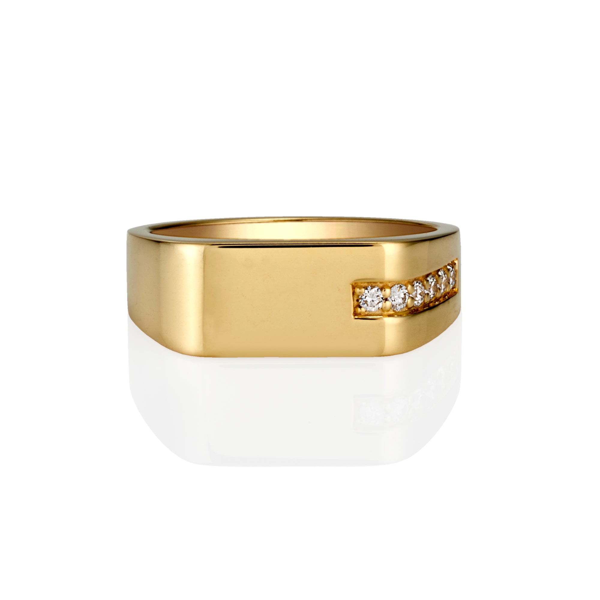 A yellow gold signet-style ring with a row of small round diamonds on the front, shown on a clean white background with a soft reflection below.