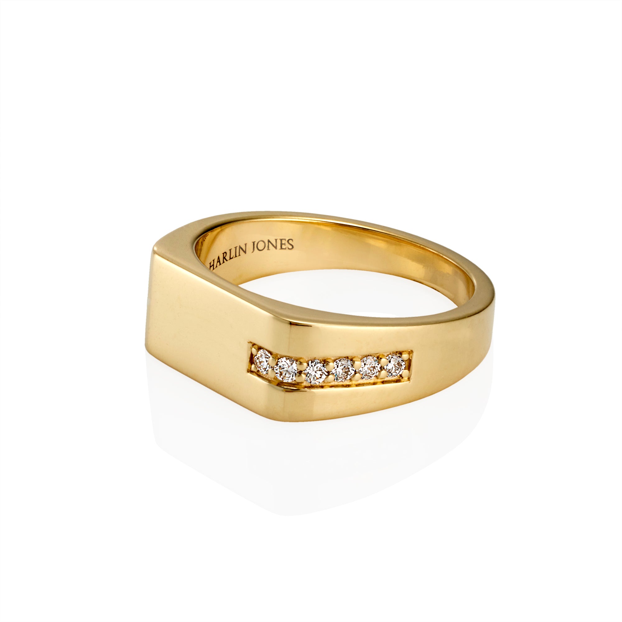 A gold signet-style ring with a row of small round diamond set across the front, photographed on a clean white background. The inside of the band is engraved with the brand name 'HARLIN JONES'.