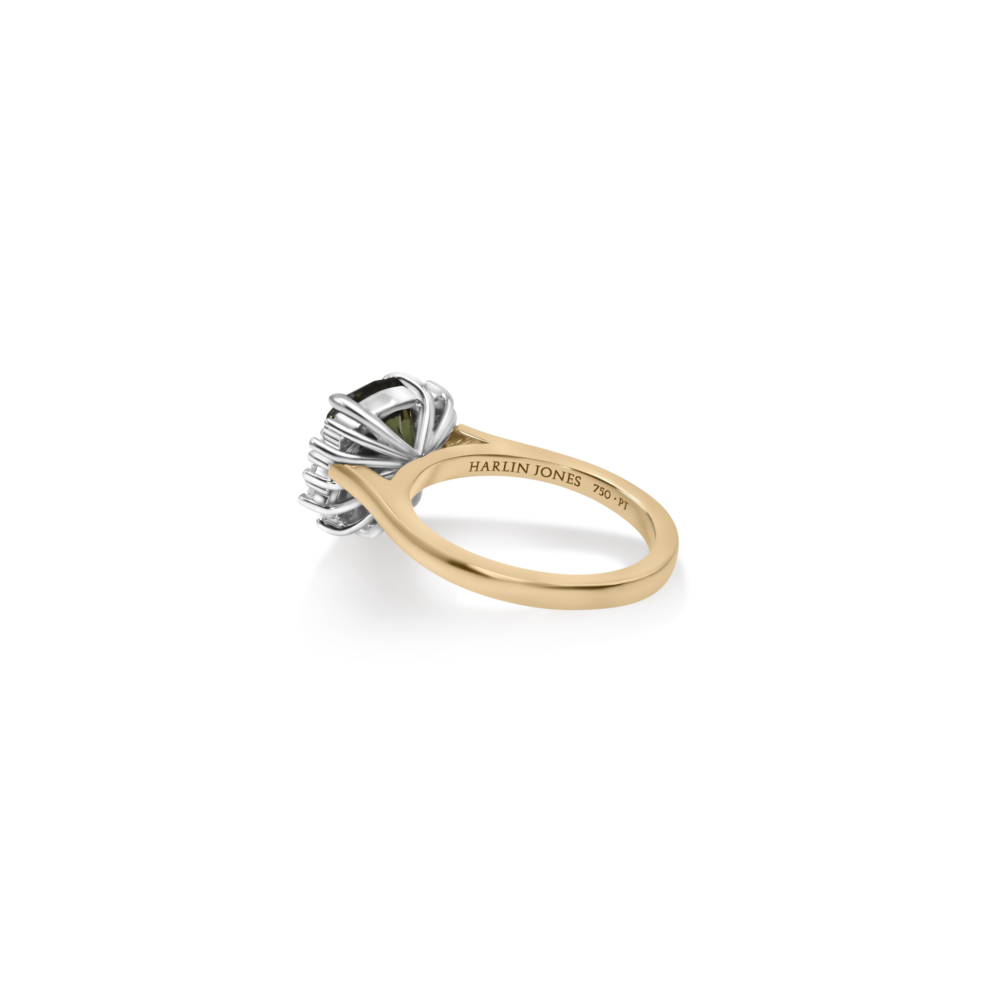 Yellow and white gold ring sitting sideways showing a basket setting holding a green Australian sapphire gemstone