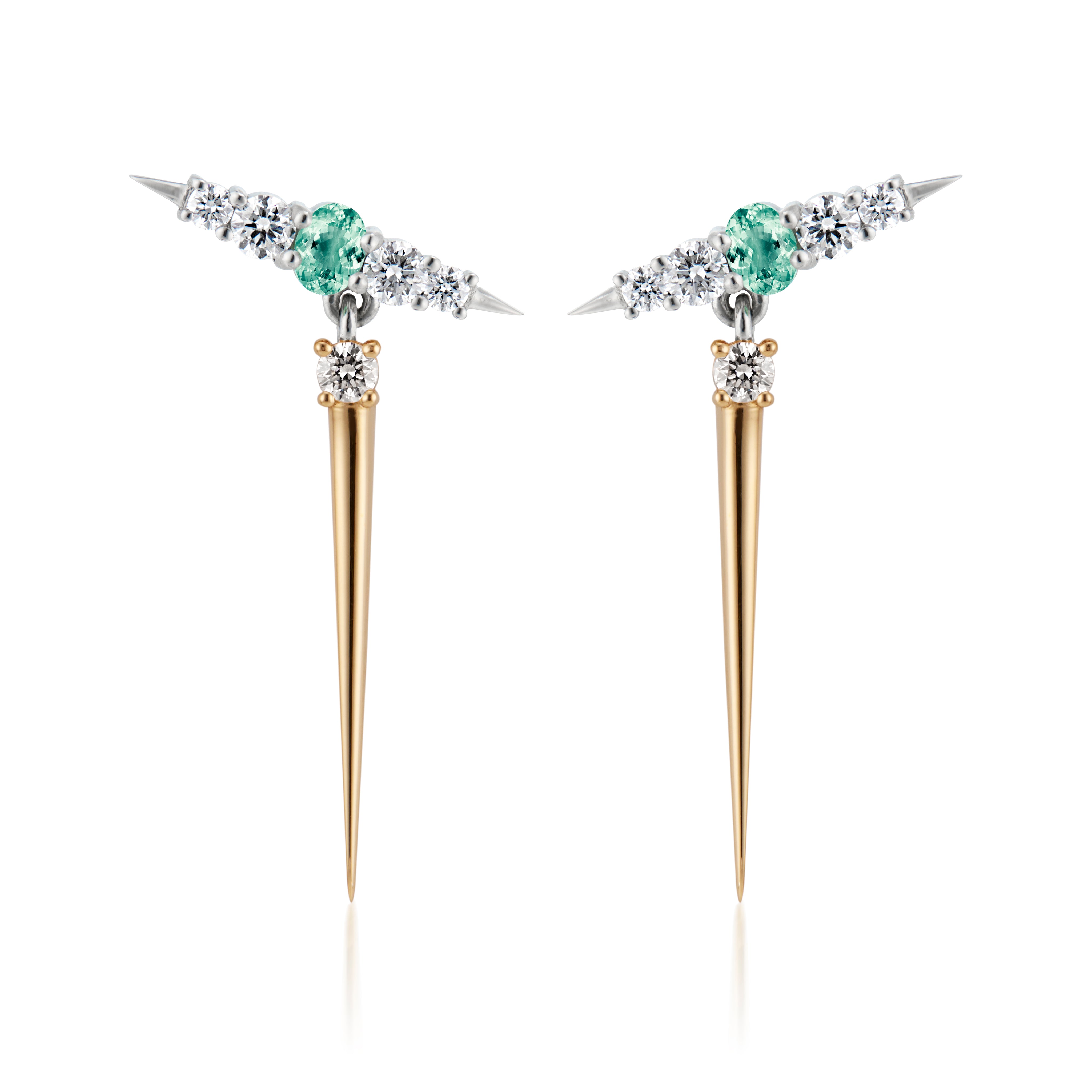 pair of earrings that feature vibrant green gemstones positioned between sparkling diamonds. The earrings combine both yellow gold and silver elements, showcasing a unique spike design that adds a modern flair. 