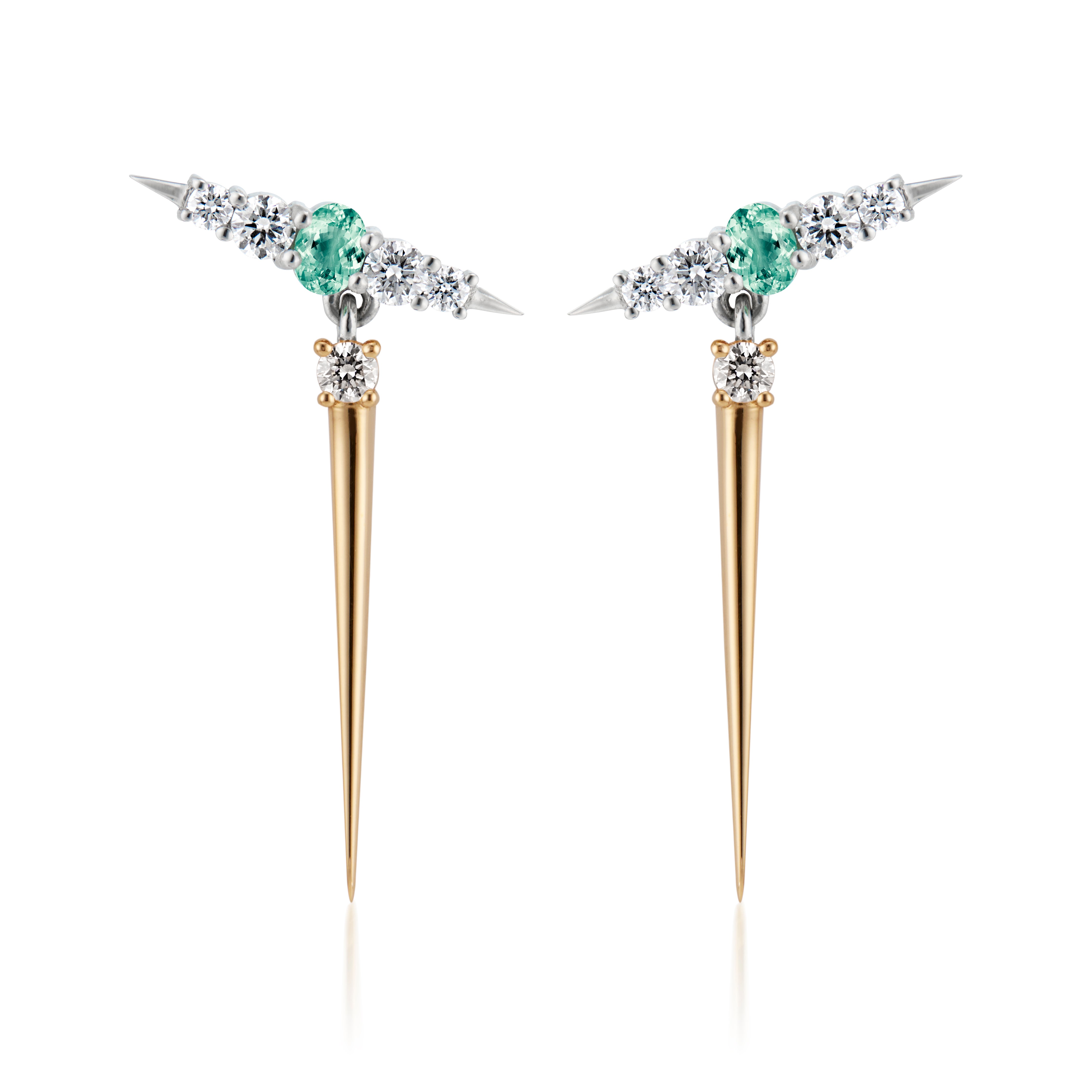 pair of earrings that feature vibrant green gemstones positioned between sparkling diamonds. The earrings combine both yellow gold and silver elements, showcasing a unique spike design that adds a modern flair. 