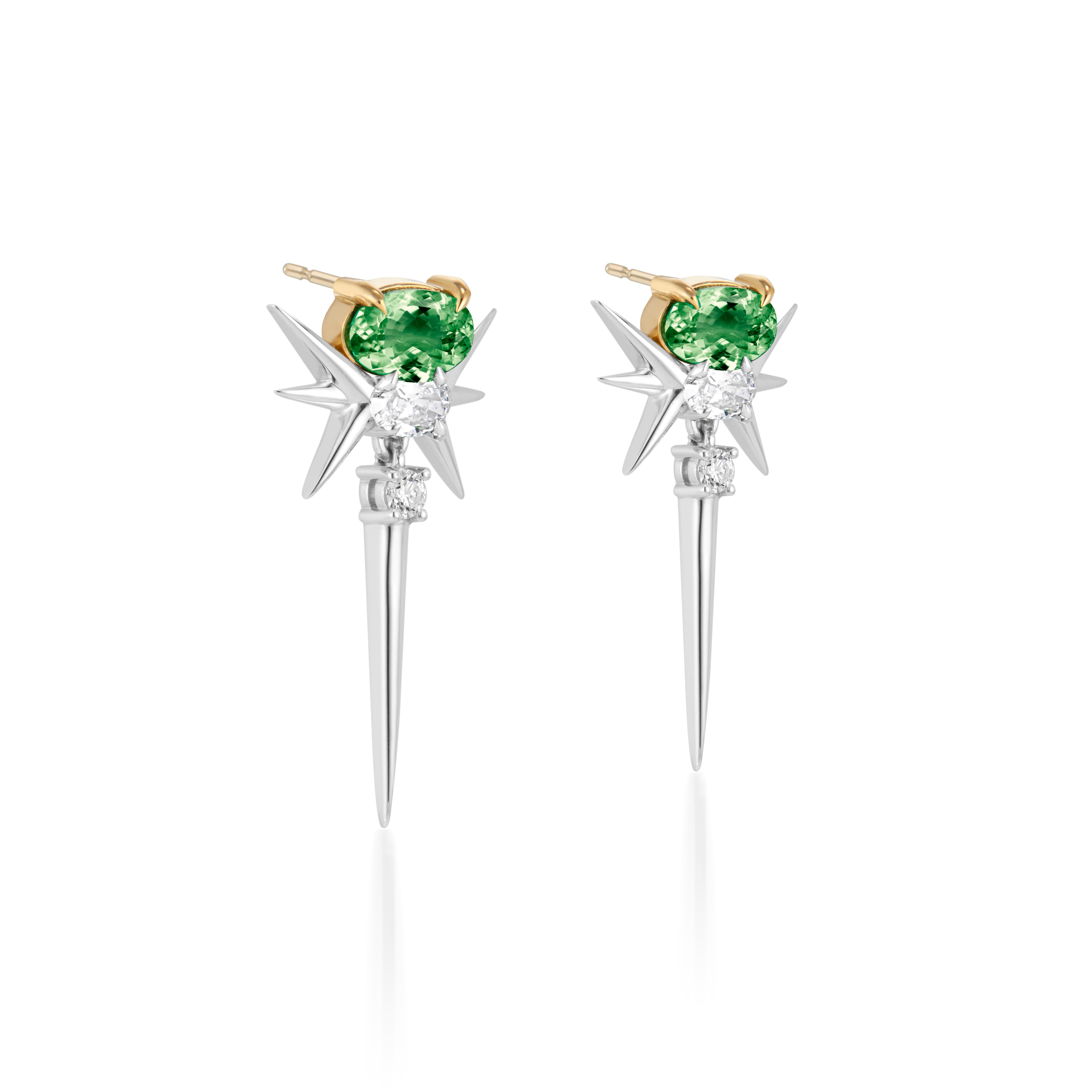 Stylish earrings featuring green gemstones set in gold prongs, complemented by silver starburst spikes and smaller accent stones."

