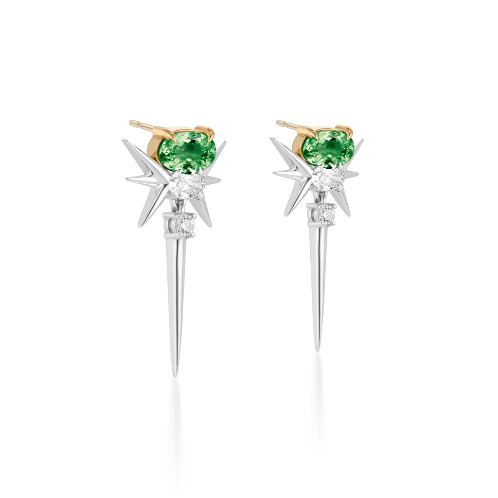Stylish earrings featuring green gemstones set in gold prongs, complemented by silver starburst spikes and smaller accent stones."
