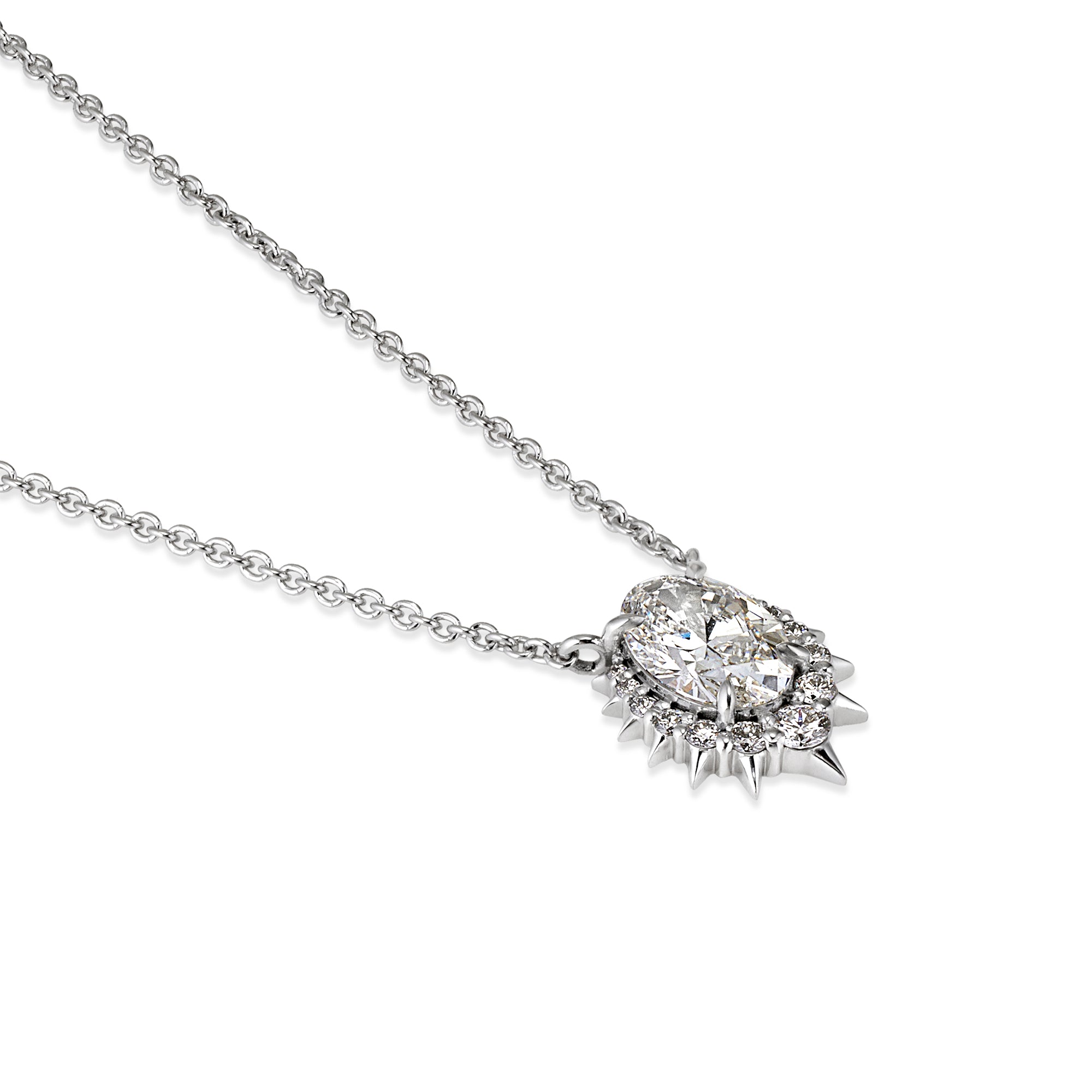 A silver-toned chain necklace featuring a unique pendant with a large clear oval center stone surrounded by smaller clear stones and sharp spiky details, shown on a plain white background.