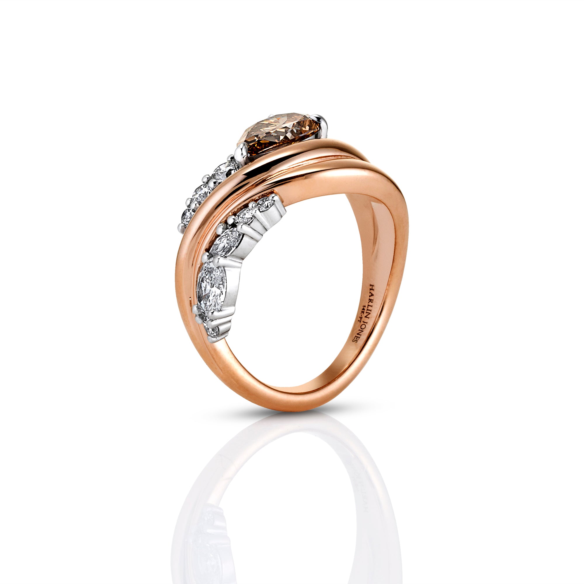 A rose gold and white gold double-band ring with a marquise-cut diamond center stone and smaller diamonds along the band, shown on a clean white background with a soft reflection.
