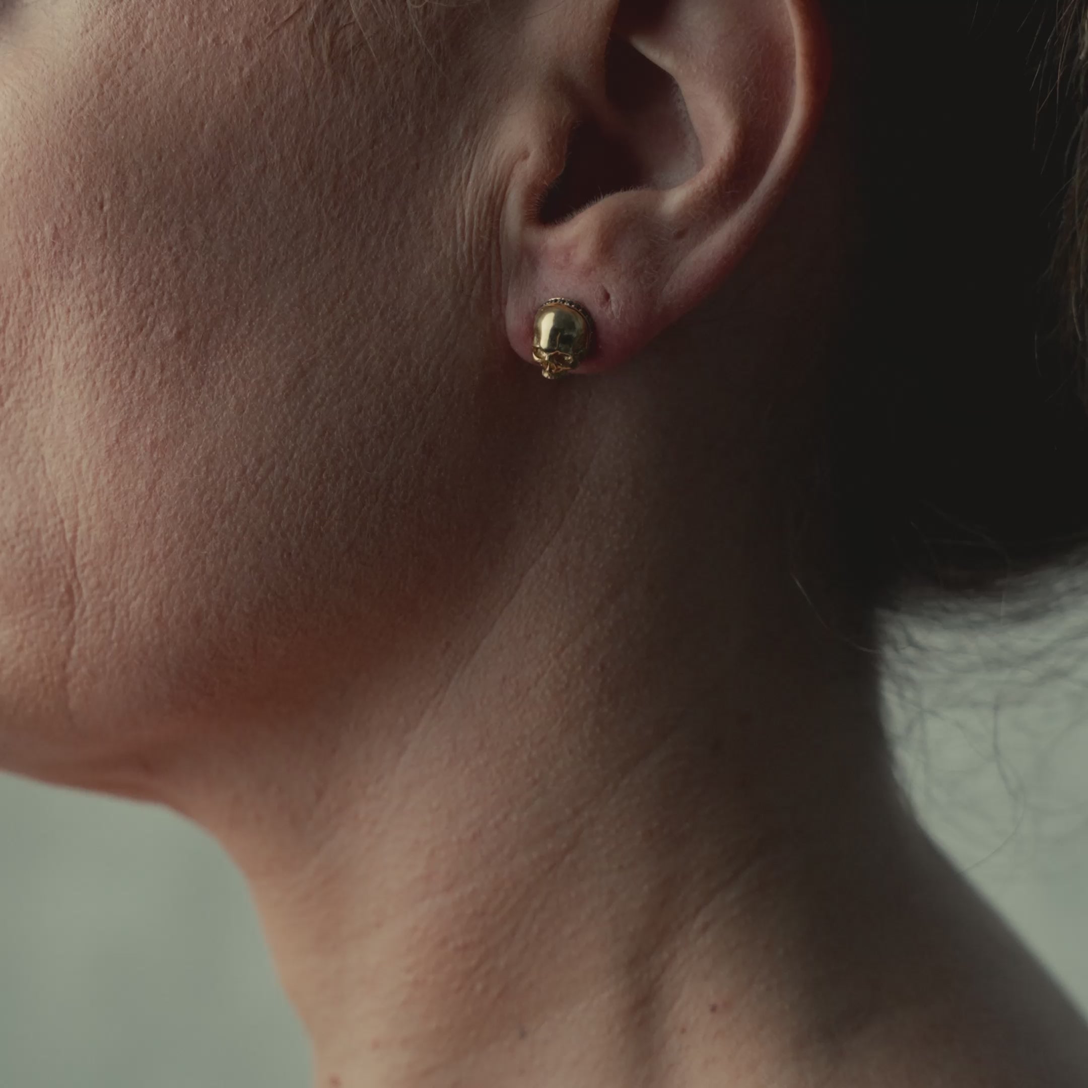 Video of model wearing skull earrings