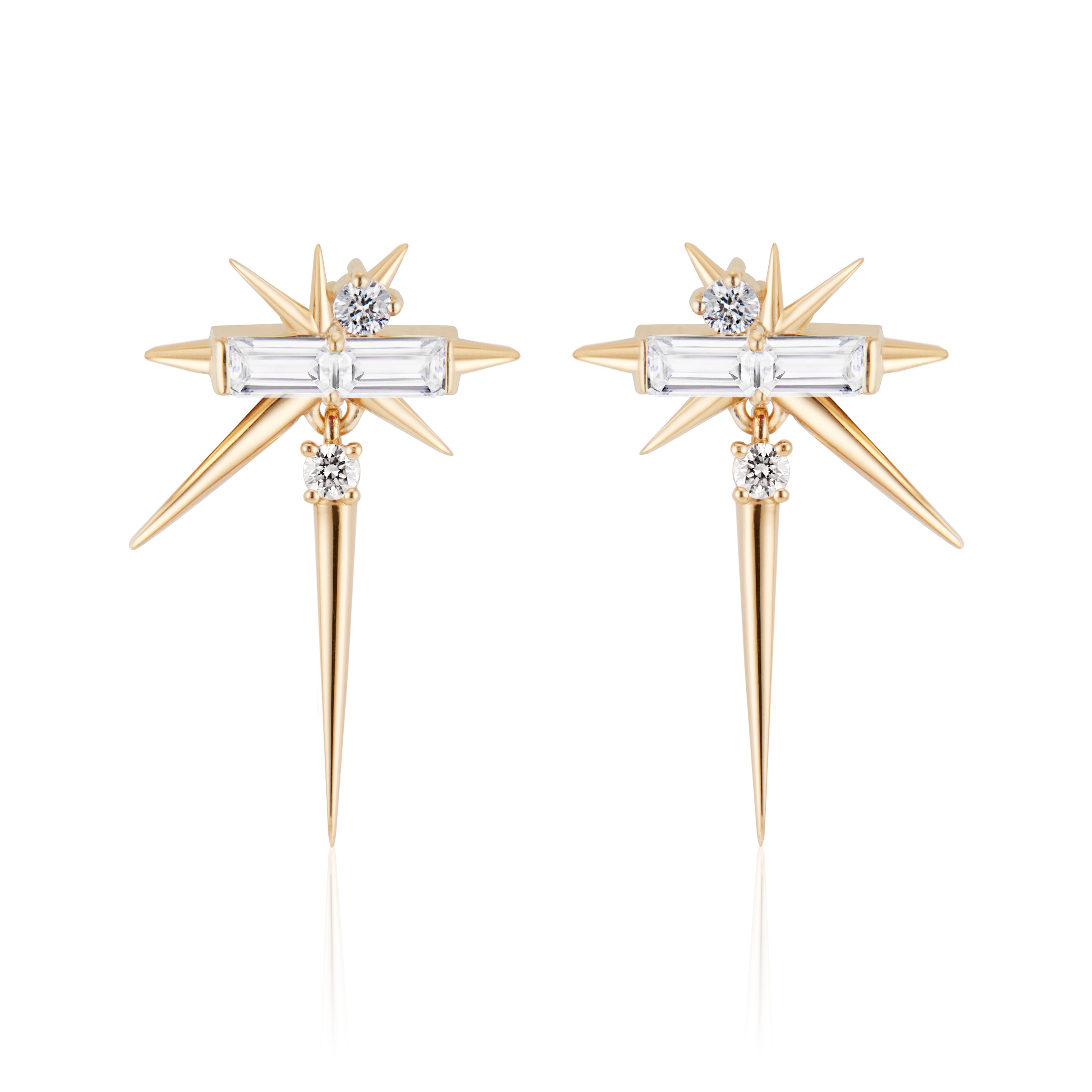 Gold starburst earrings with baguette and round diamonds, isolated on white background.