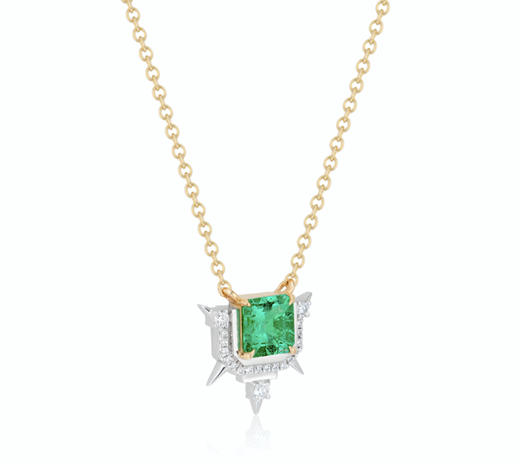 Gold necklace with a green emerald pendant surrounded by diamonds.
