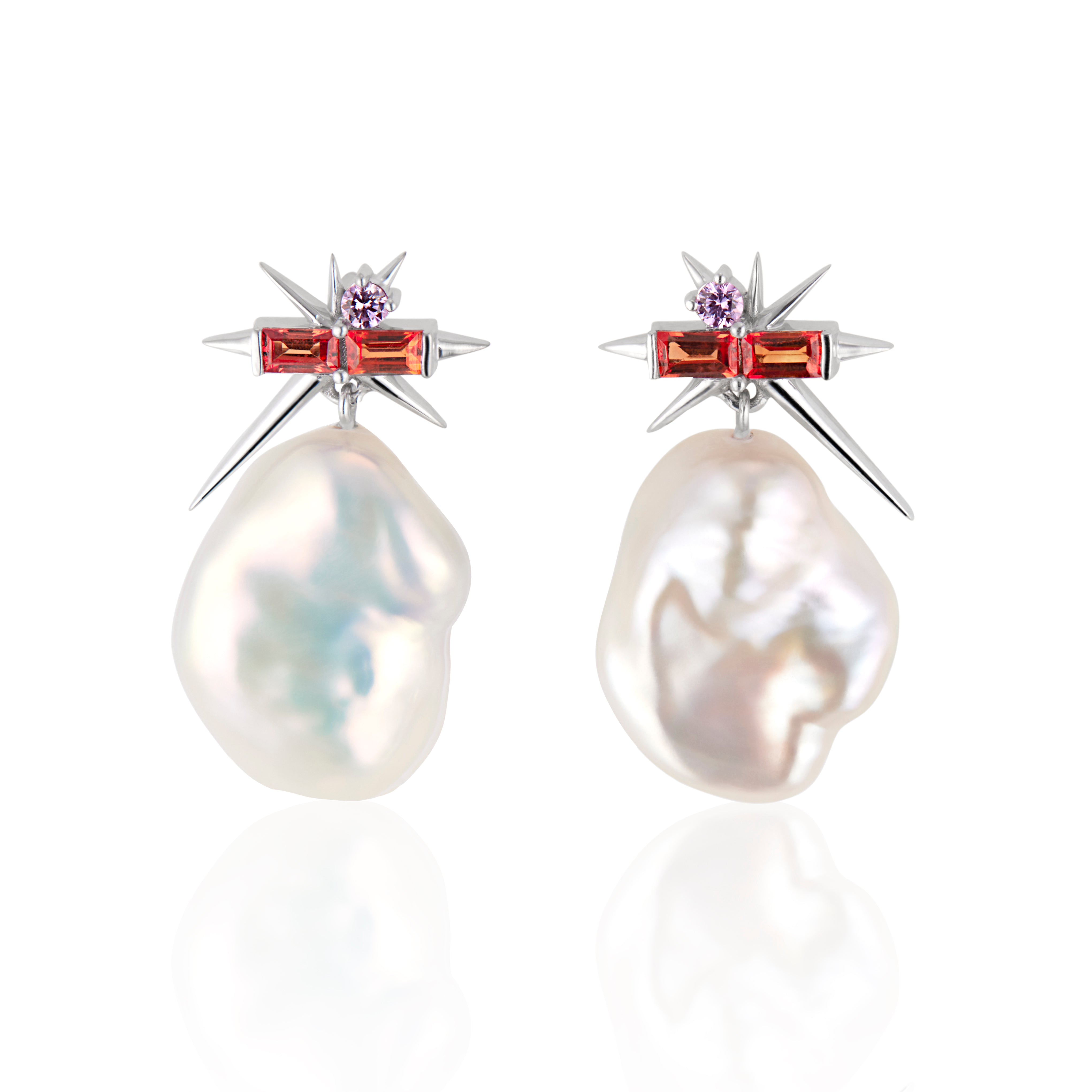 Pair of pearl earrings with star-shaped tops and orange gem accents on white background.