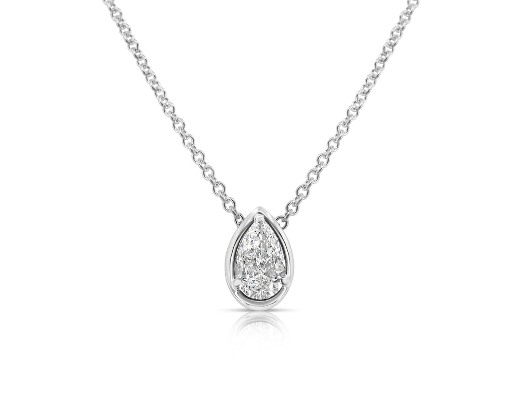 Front view of vertical pear-shaped diamond pendant necklace pointed up. The diamond is set in a white gold pear-shaped beveled setting, fixed with 3 rounded prongs. The white gold round-link chain connects at the back of the setting near the point.