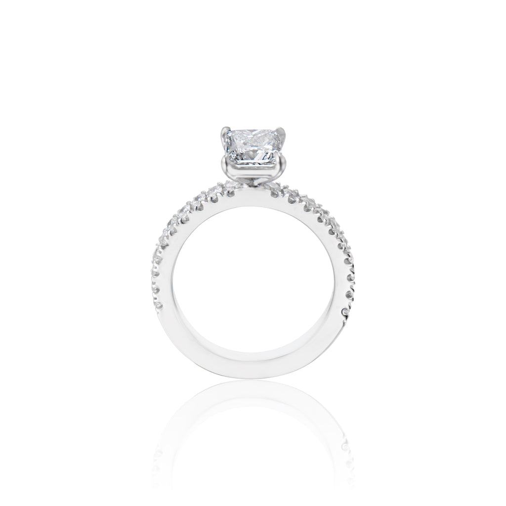 White gold engagement ring with a centred single large diamond and small diamonds on the band, isolated on white.