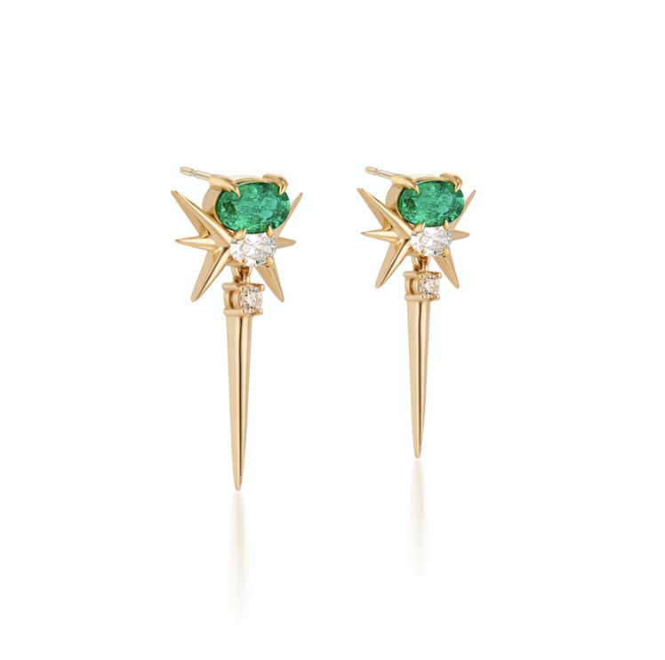 Gold earrings with green emerald gemstone tops, starburst design, and a dangling diamond spike.
