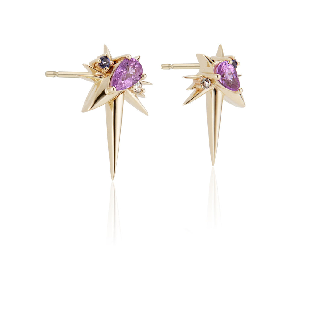 Gold star-shaped earrings with central purple gemstones and small diamonds, isolated on white.