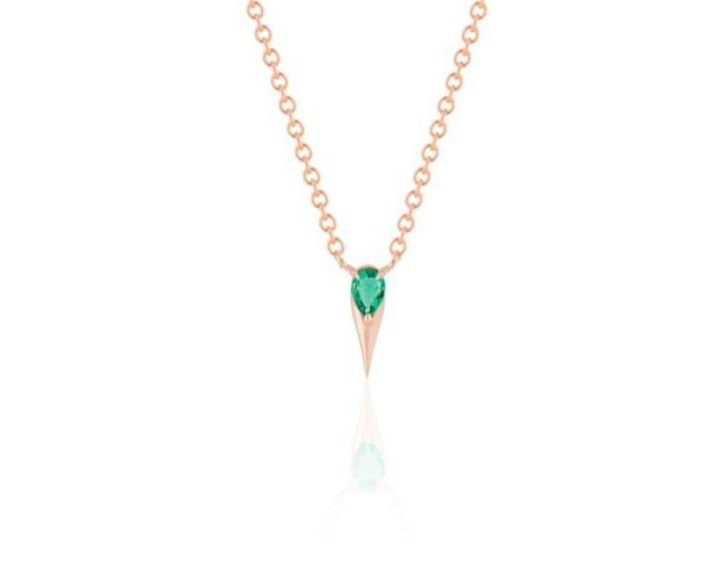 Front view of unique emerald pendant necklace connected to a rose gold round-link chain by 2 angled rose gold prongs. The pear-shaped emerald stone is set at the top of a rose gold spike that drops below, forming a water droplet shape.