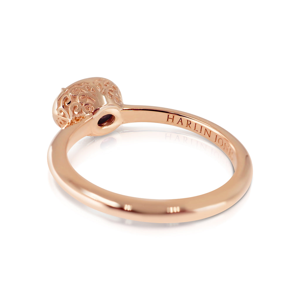Back view of handmade rose gold filigree ring shows a small round hole on the interior band at the bridge. There is a Harlin Jones engraving along the side of the flat interior shank. The decorative filigree basket flares out from the band.