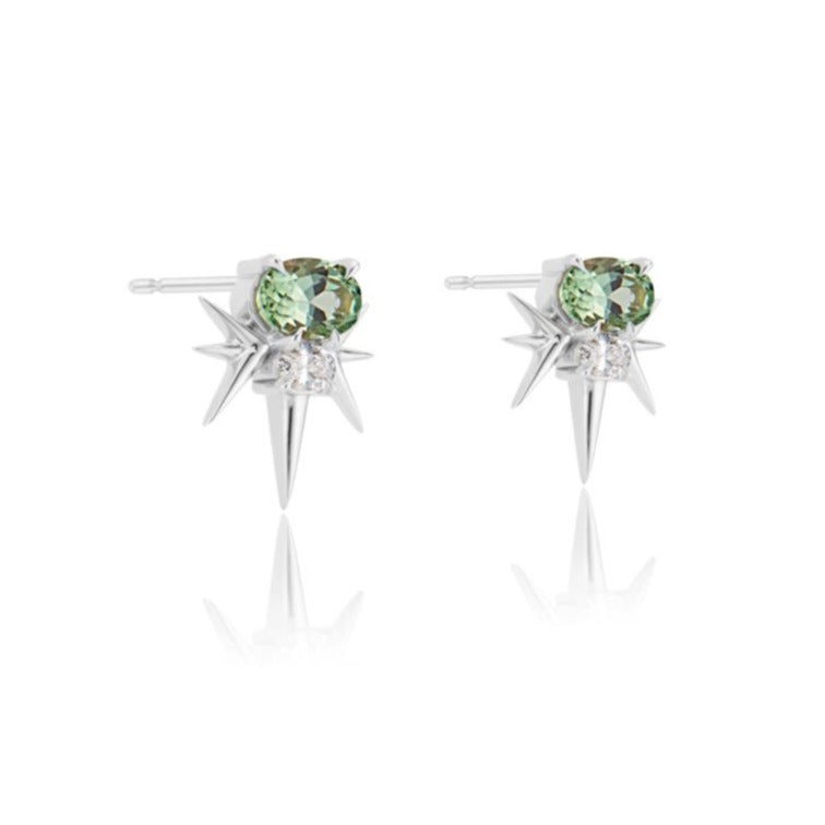 A pair of silver starburst earrings with central green gemstones.