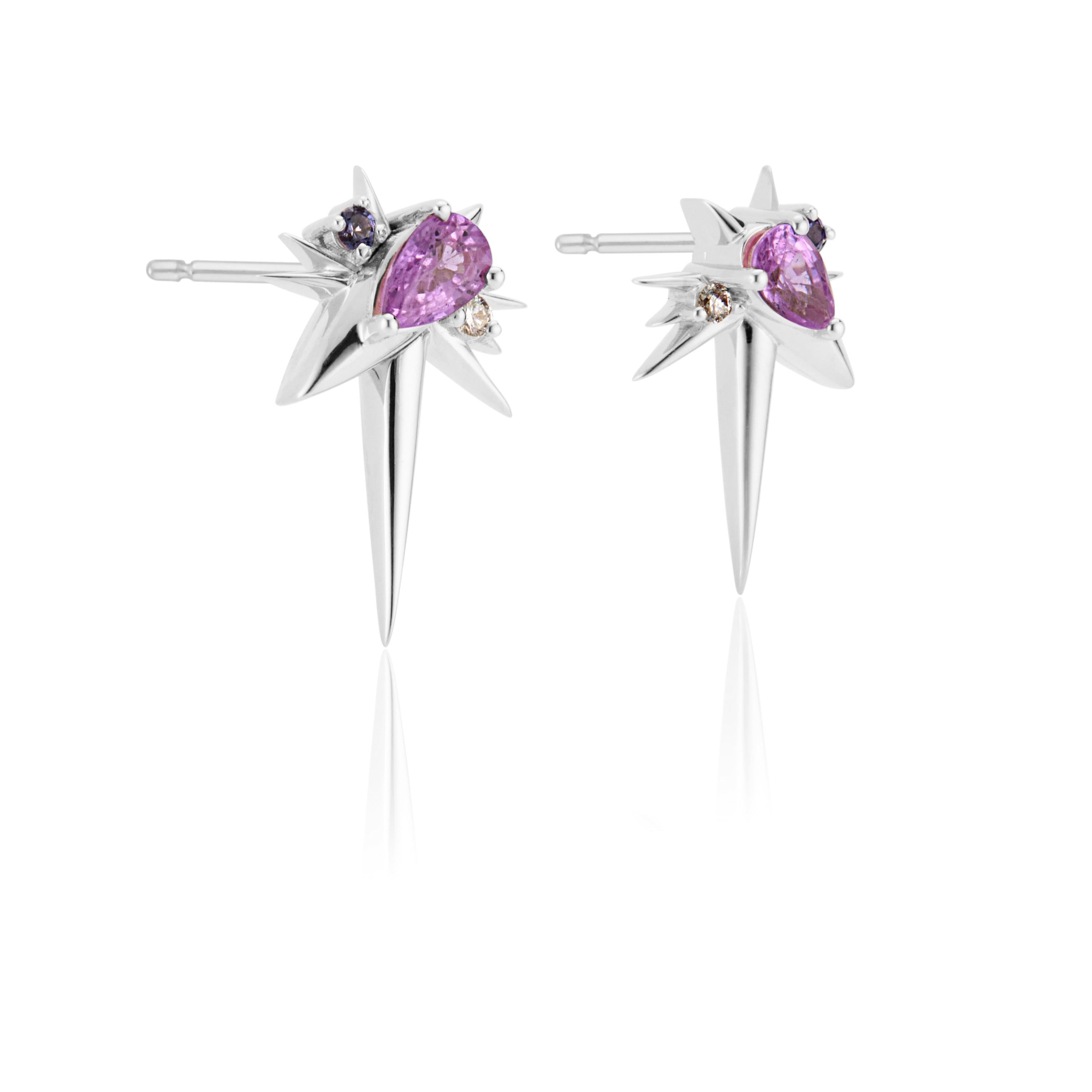 A pair of star-shaped silver earrings with pink gemstones and small diamonds.