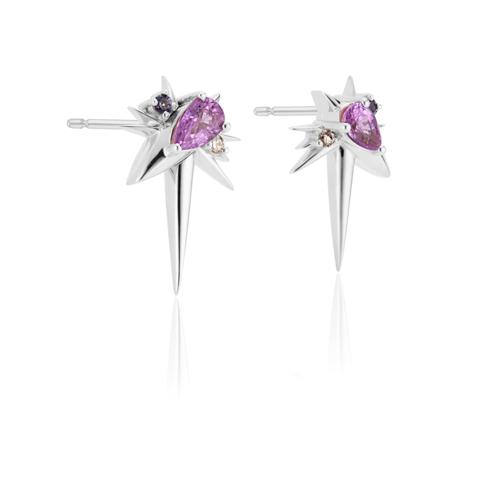 A pair of star-shaped silver earrings with pink gemstones and small diamonds.