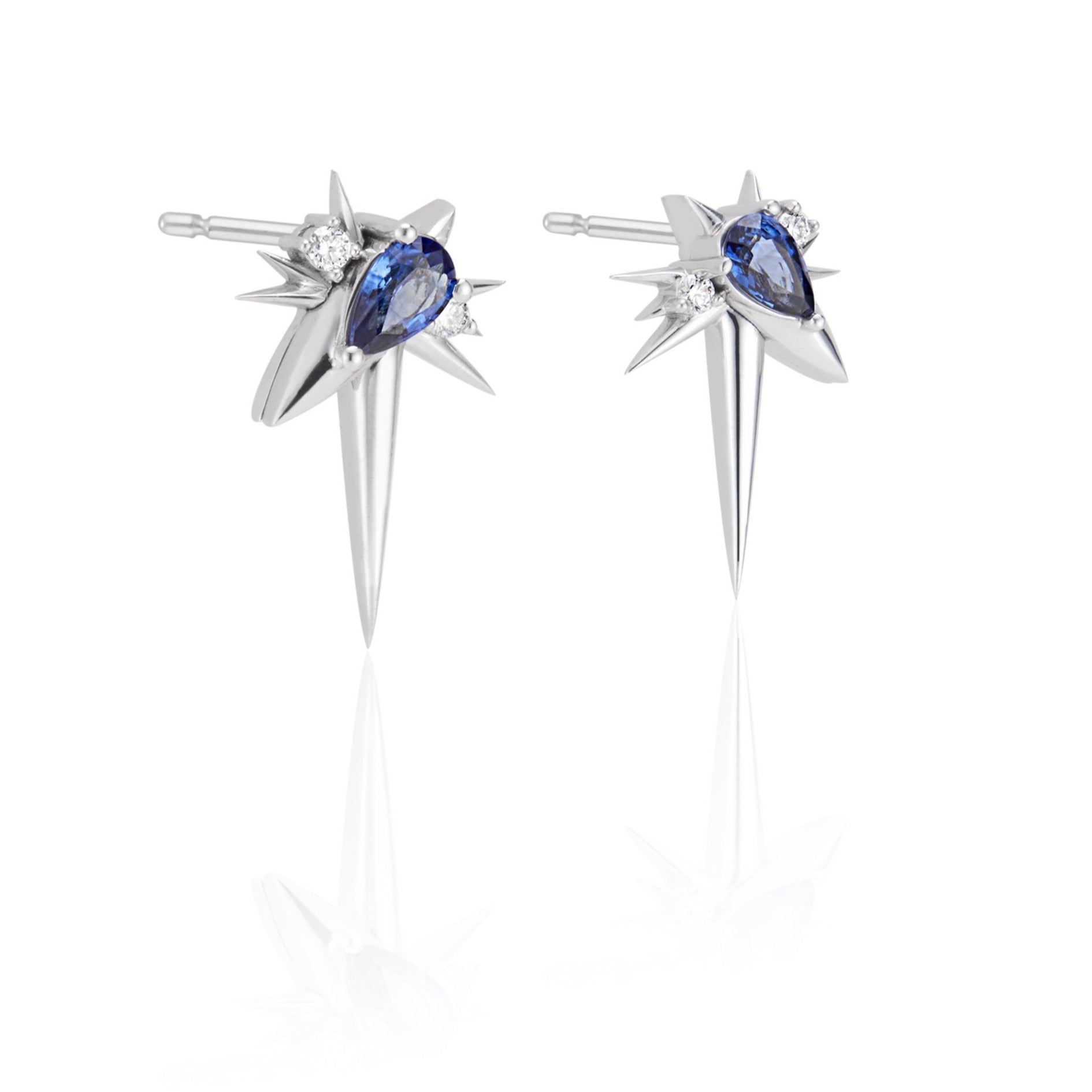 A pair of silver star-shaped earrings with blue gemstones and small diamonds.