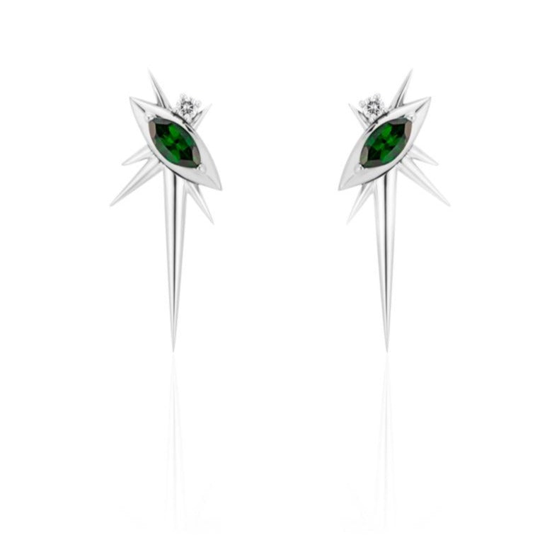 Front view of alternative drop earrings, each with 1 marquise-shaped tsavorite, set at a 45-degree angle, with a small round diamond above. 6 white gold spikes of varying lengths extend from the setting, with a large, long spike pointed down. 