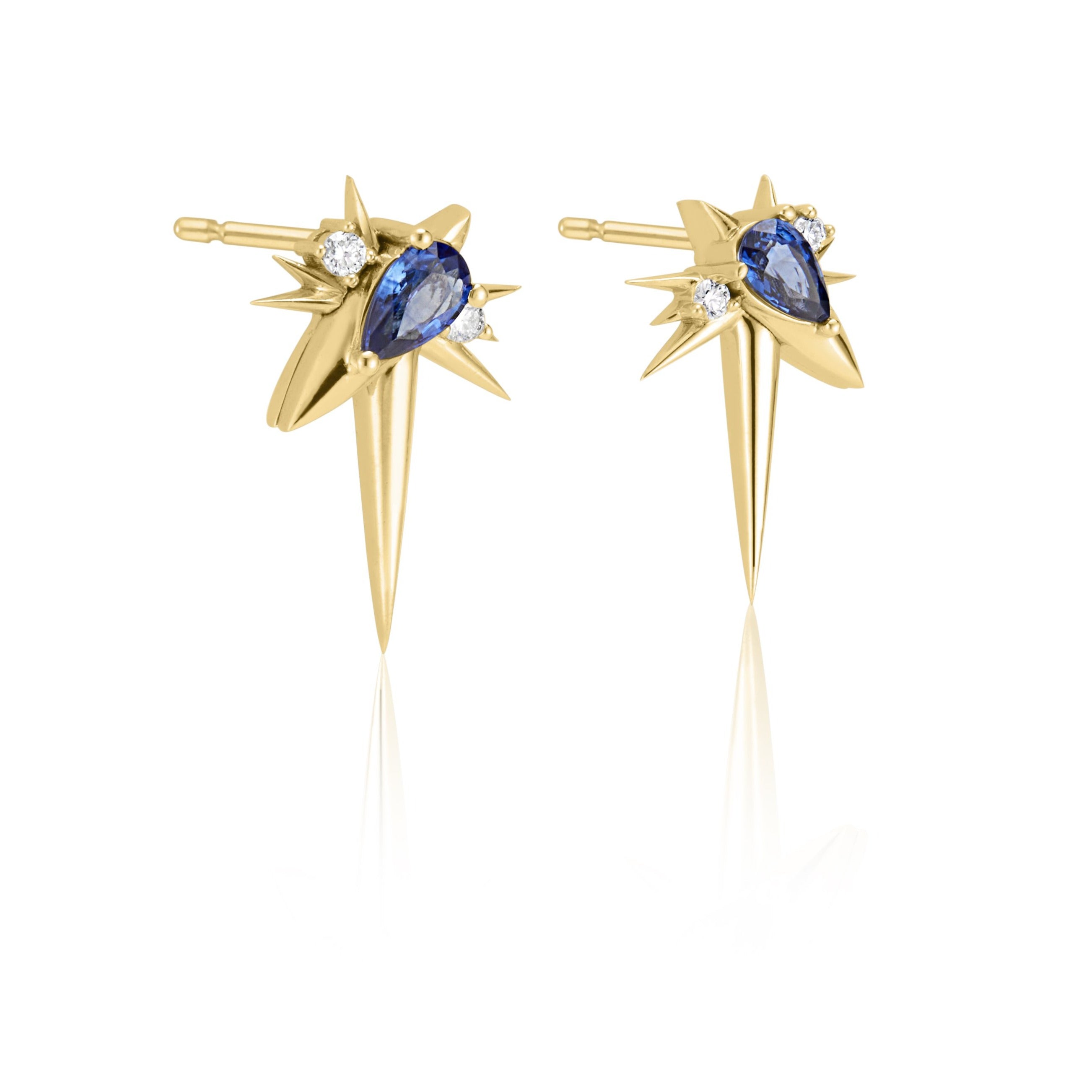 Gold starburst earrings with central blue gemstones and accent diamonds.